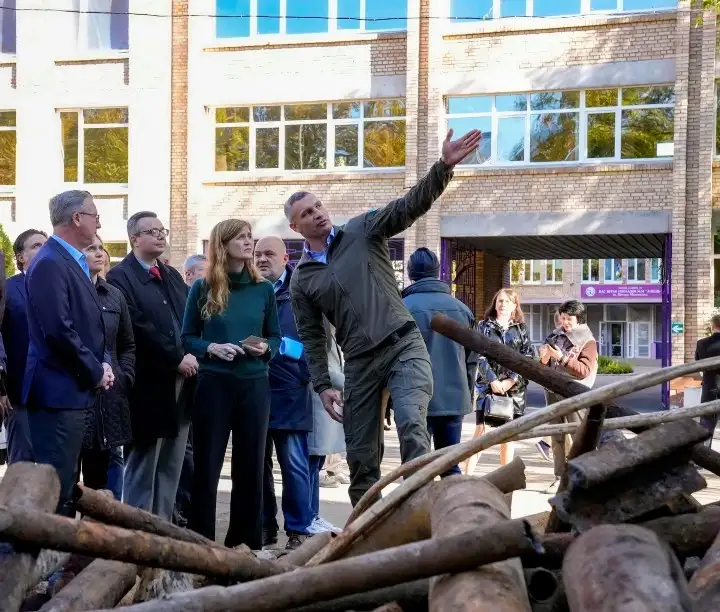USAID Administrator Samantha Power during a visit to Ukraine in 2022 looks at damage to a school caused by the war. The school underwent repairs to its infrastructure so heat could be restored. / USAID